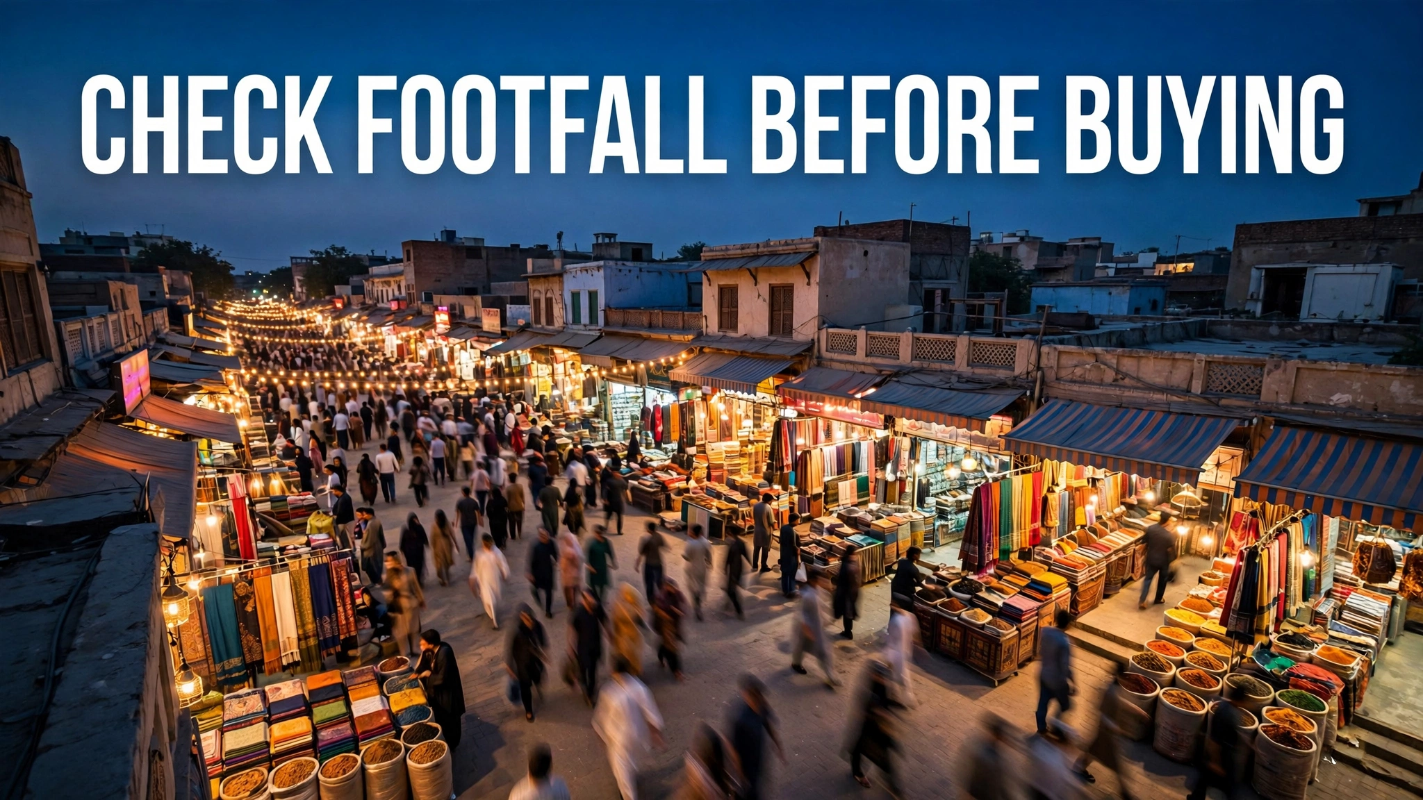 Elevated evening street view of a busy Pakistani bazaar with shoppers walking past lit open shops, with the headline 'CHECK FOOTFALL BEFORE BUYING'